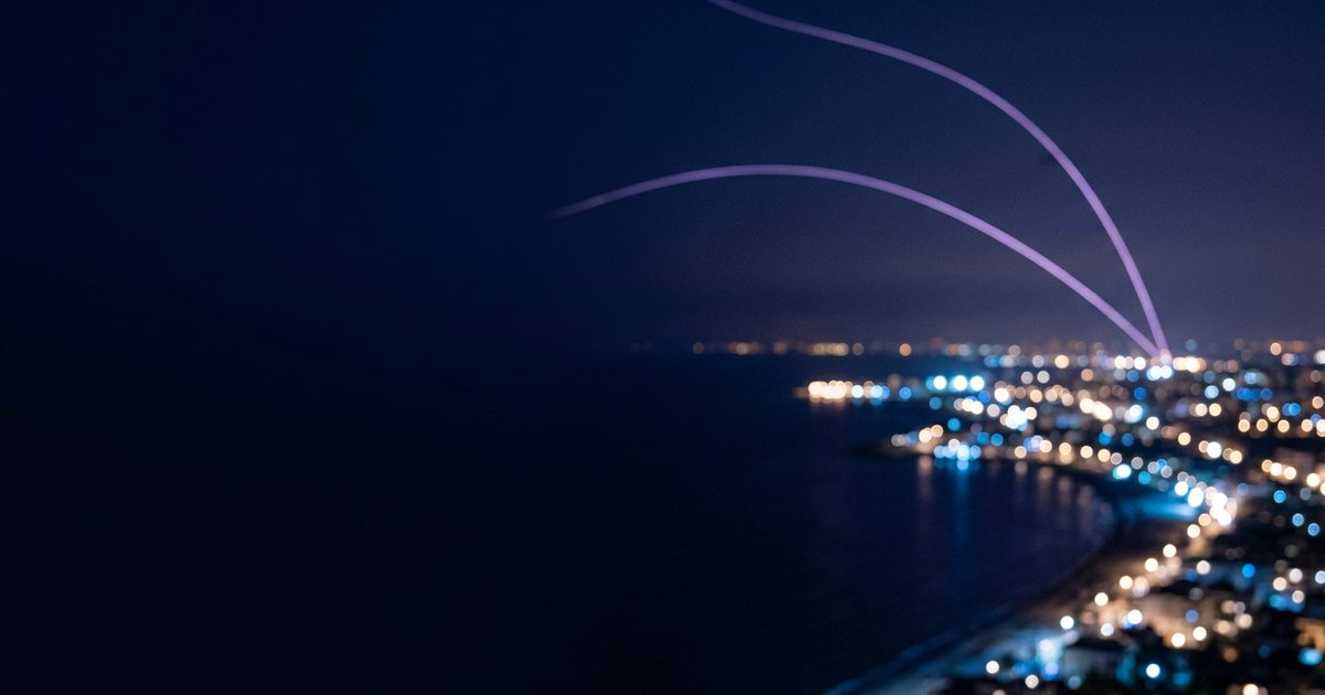 Coastline city lights seen from above with arcs of light linking them